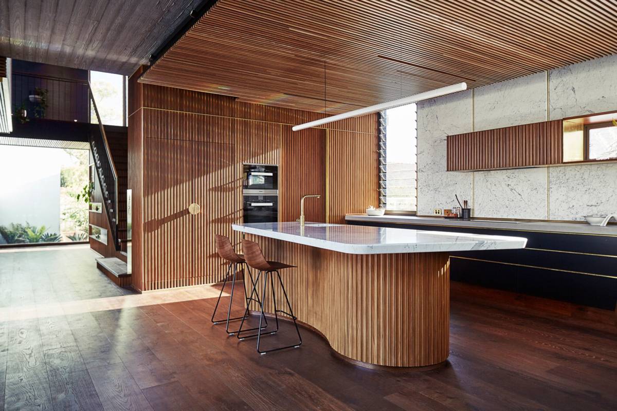 Picture of a wooden and marble kitchen island table with light bar